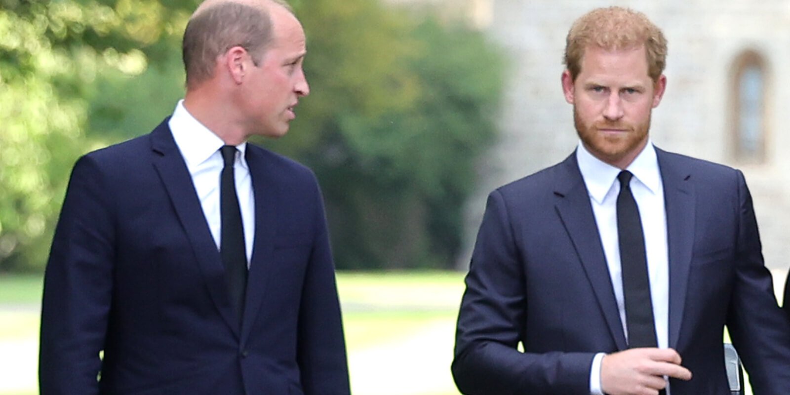 Prince William looks at Prince Harry during a walkabout after Queen Elizabeth II's death.