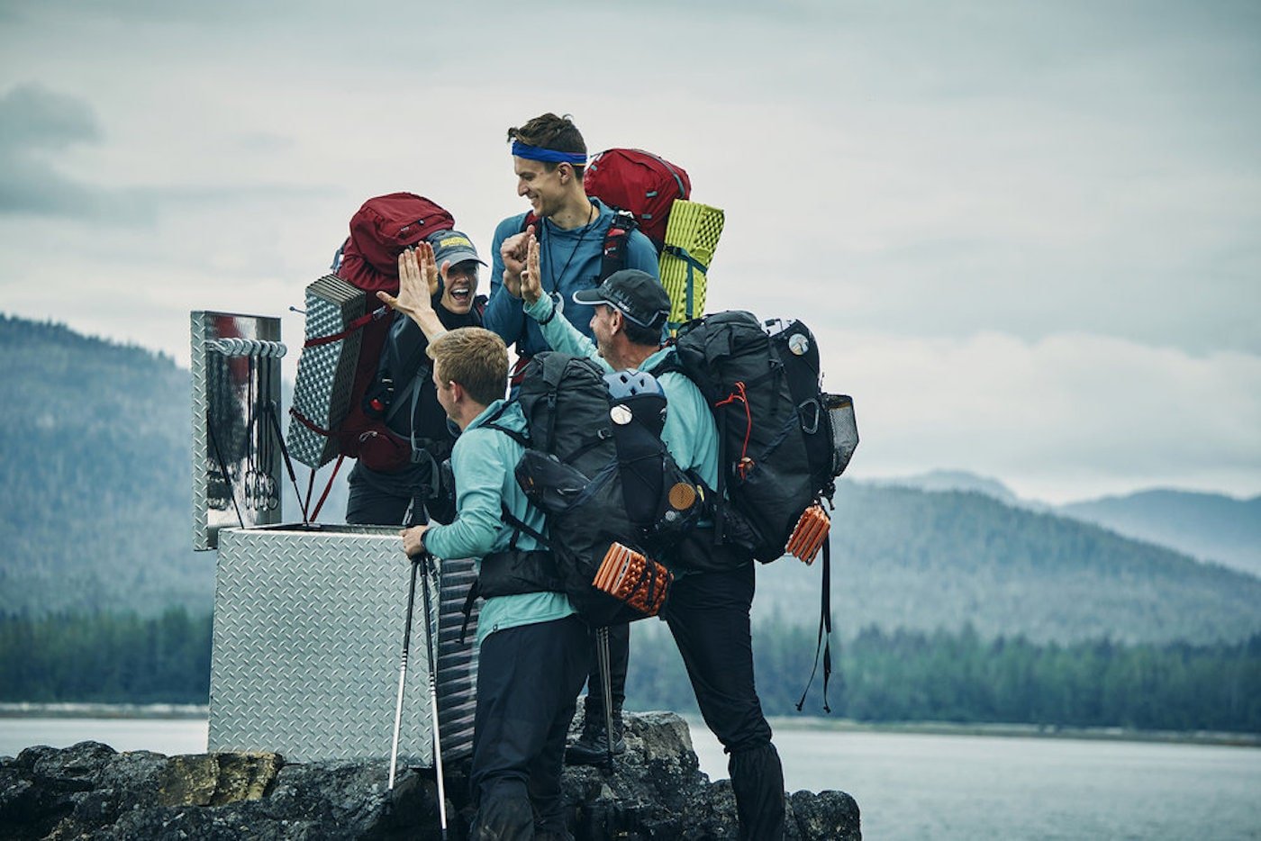 'Race to Survive Alaska' cast high five each other at the finish line