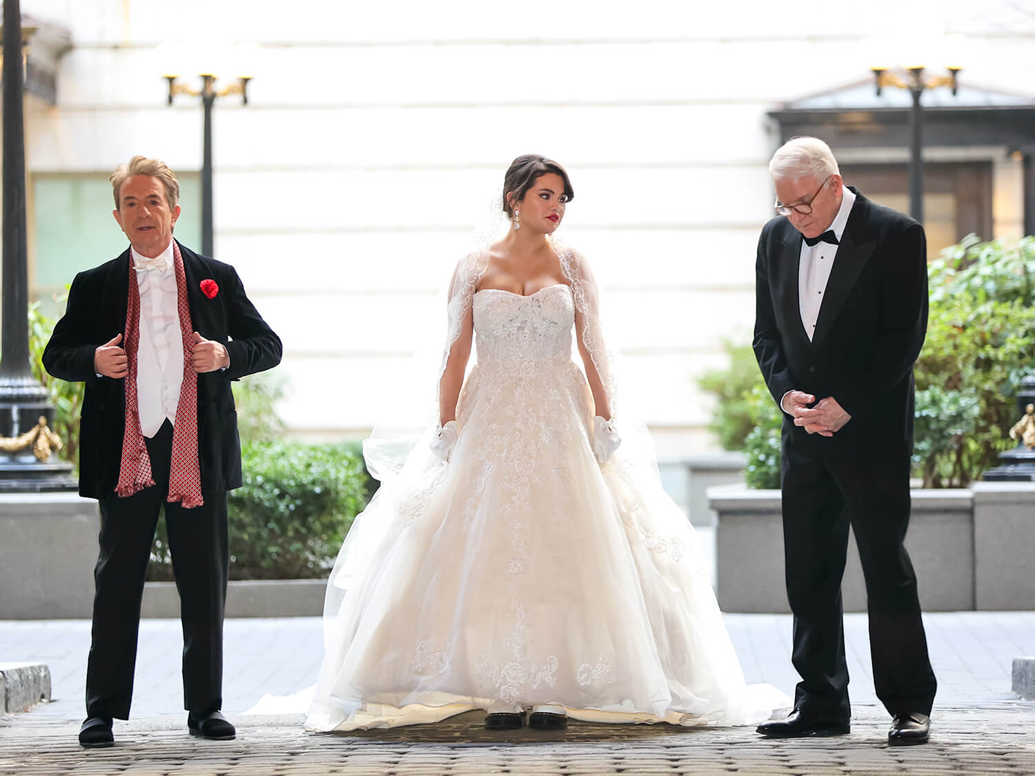 Martin Short, Selena Gomez, and Steve Martin in tuxedos and a wedding dress while filming Only Murders in the Building Season 3.
