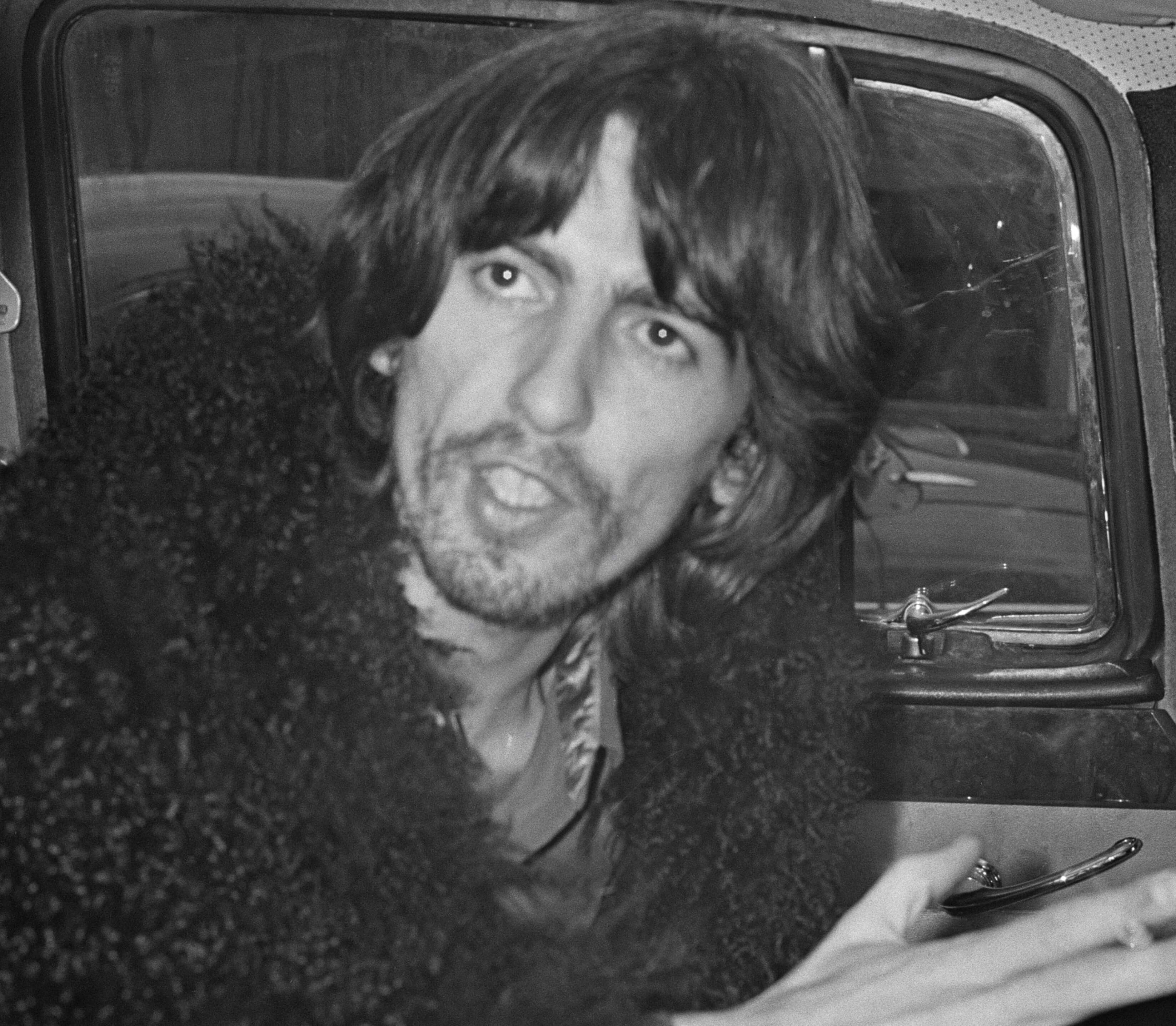 George Harrison, writer of The Beatles' "Here Comes the Sun," in a car