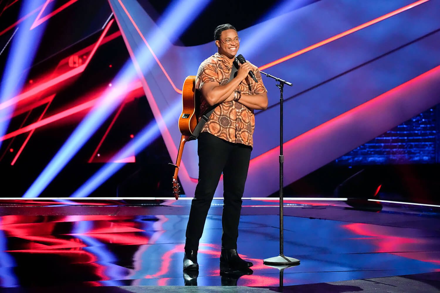 NOIVAS smiles on stage after earning four chair turns on The Voice Season 23