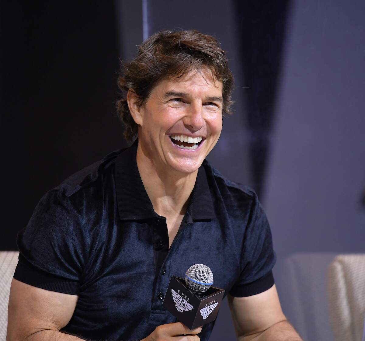 Actor Tom Cruise laughs during a press conference of the movie 'Top Gun: Maverick'
