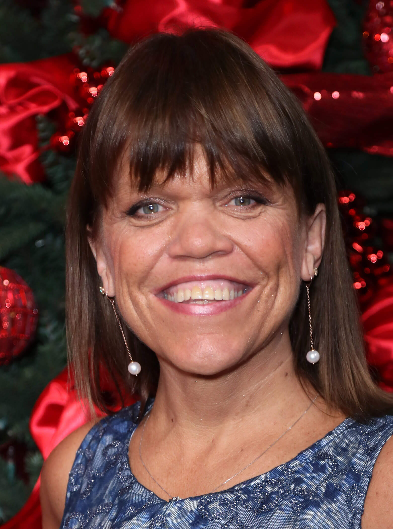 A close-up of Amy Roloff smiling from 'Little People, Big World'