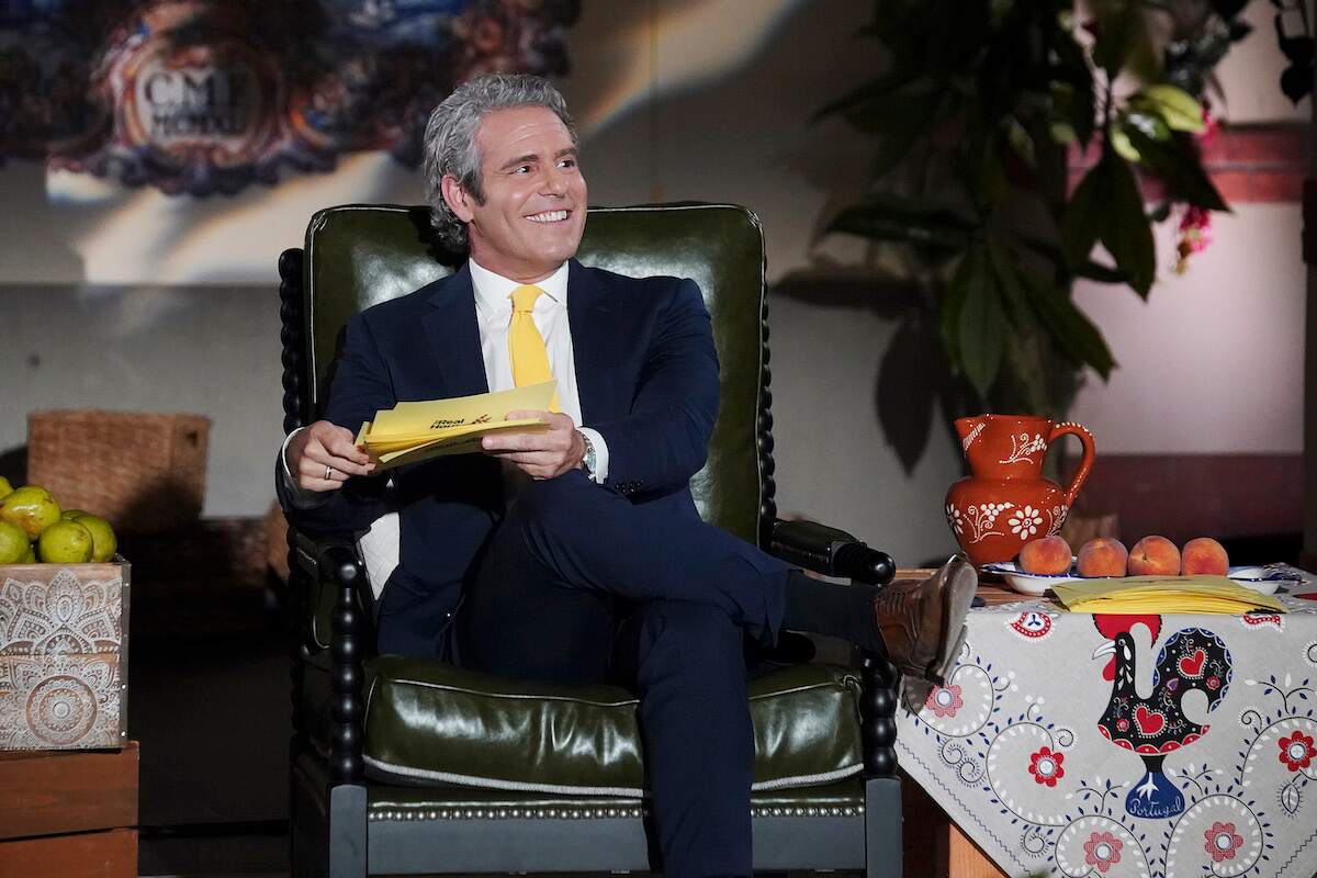 Andy Cohen smiles during a Real Housewives reunion