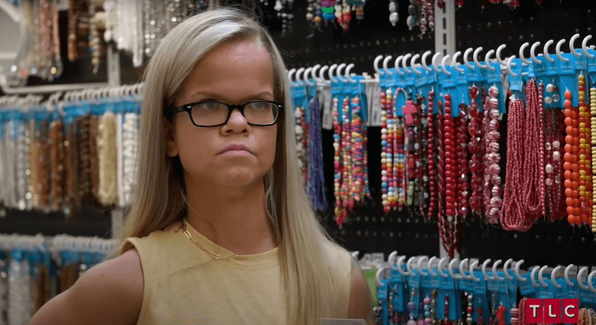 Anna Johnston standing in front of a jewelry display in '7 Little Johnstons'