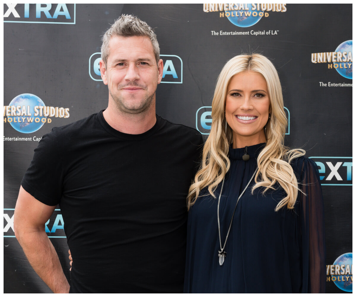 Ant Anstead and Christina Hall smile and pose together at an event.