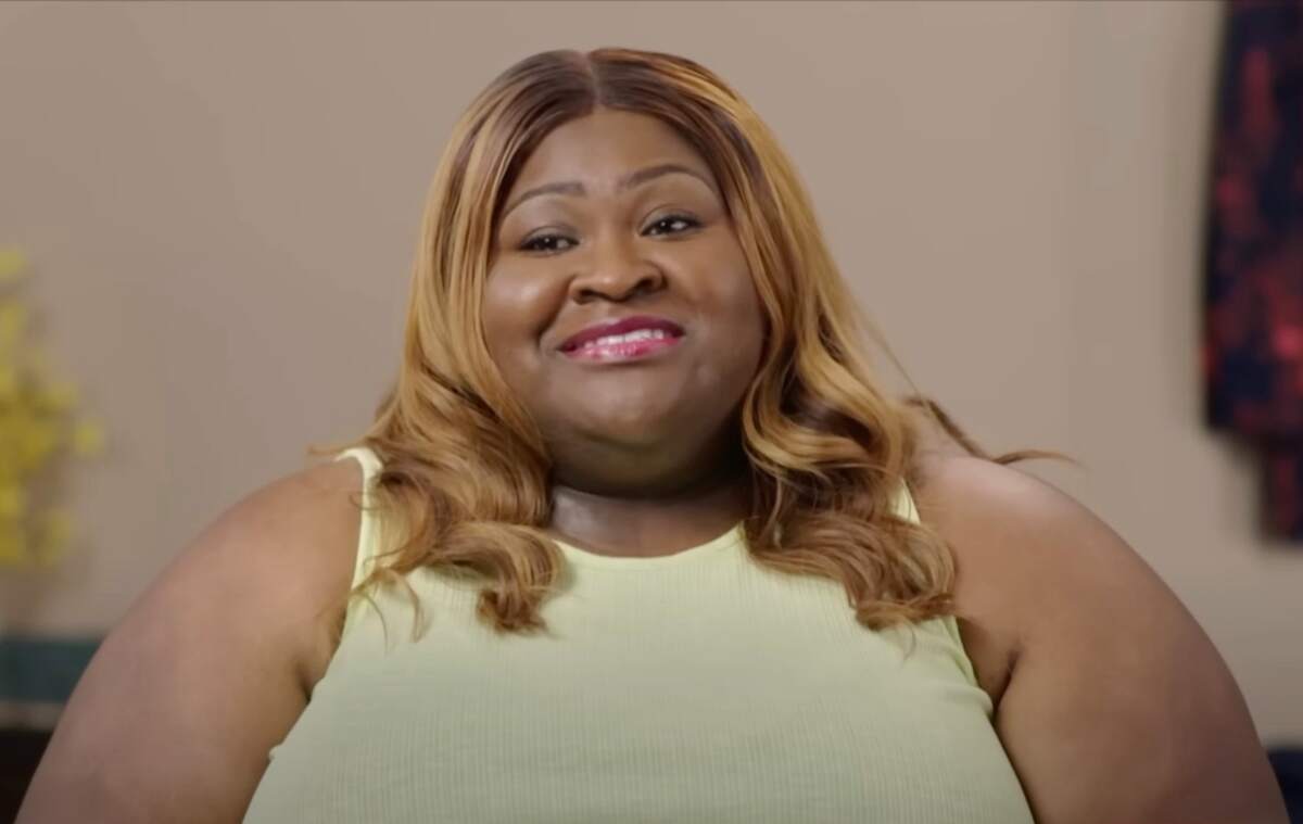 Ashely films a confessional-style interview for 1000-lb Best Friends while wearing a yellow top