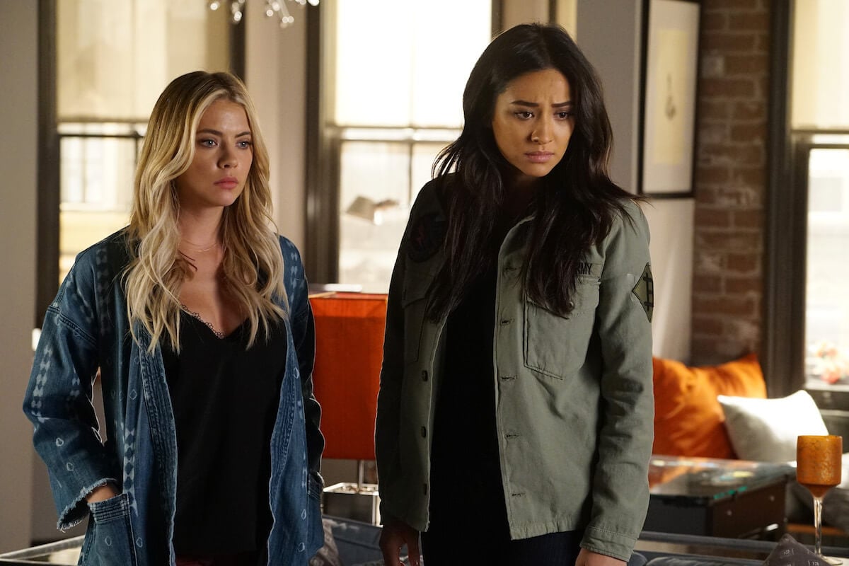Ashley Benson and Shay Mitchell standing with serious faces
