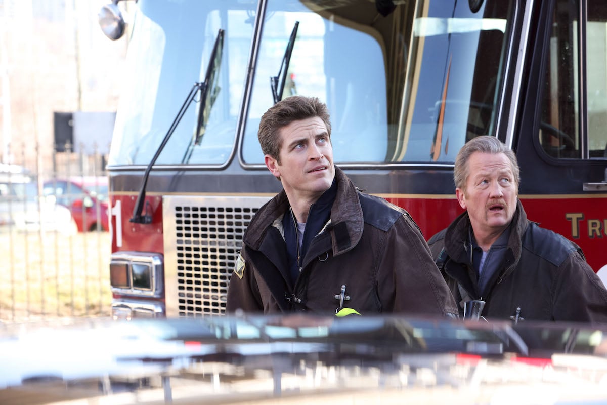 Two men standing in front of a fire truck in 'Chicago Fire' Season 11