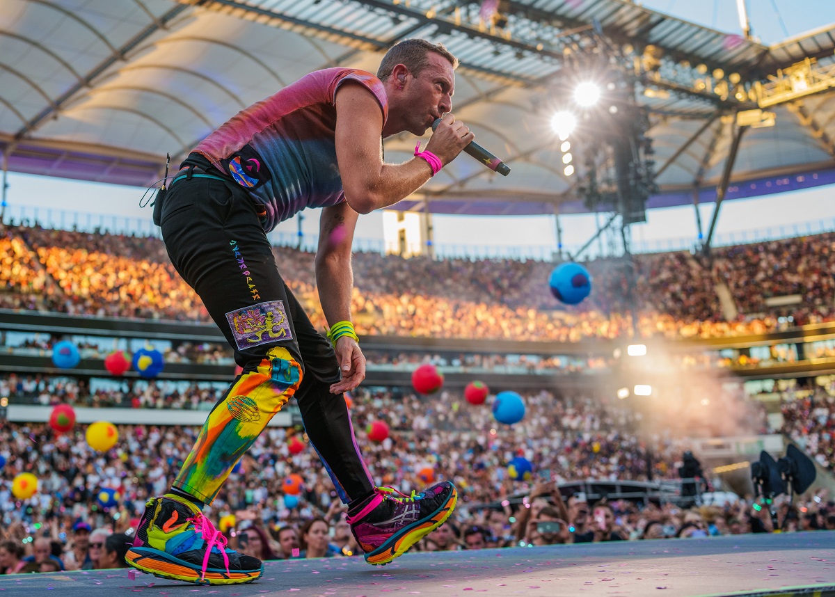 Chris Martin, dressed in black, is seen on the stage at a Coldplay concert in Frankfurt, Germany. Chris Martin recently discussed his new diet with Conan O'Brien