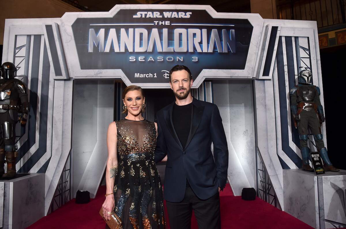 Married couple Katee Sackhoff and Robin Gadsby pose together at The Mandalorian premiere