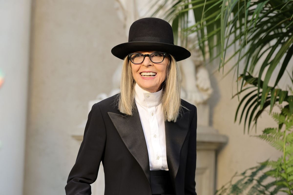 Diane Keaton poses for a photo in a suit. 
