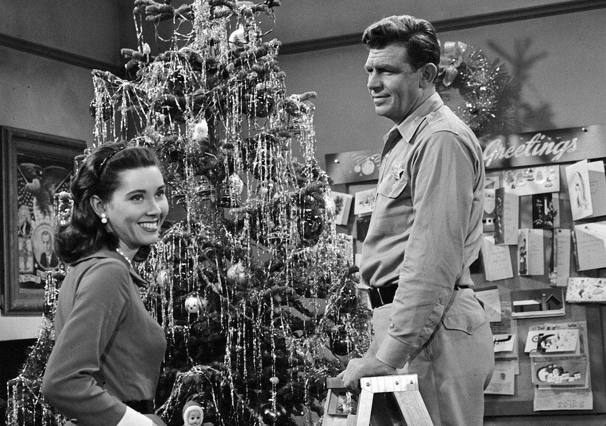 Ellie Walker and Andy Taylor decorate a Christmas tree in season 1 of 'The Andy Griffith Show'