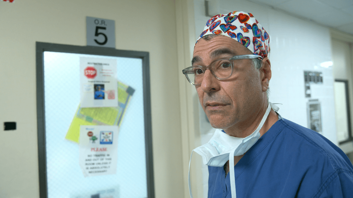 Dr. David Langer of 'Emergency NYC' on Netflix with a mask pulled down to his chin