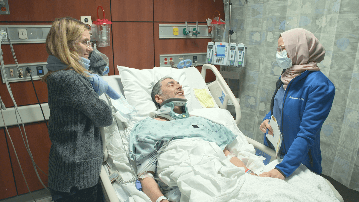 Dr. David Langer of 'Emergency NYC' on Netflix in a hospital bed surrounded by his wife and a PA