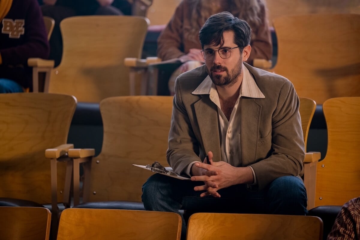 Chris McNally, wearing glasses and sitting in a theater, as Mr. Waverly in 'Firefly Lane' Season 2