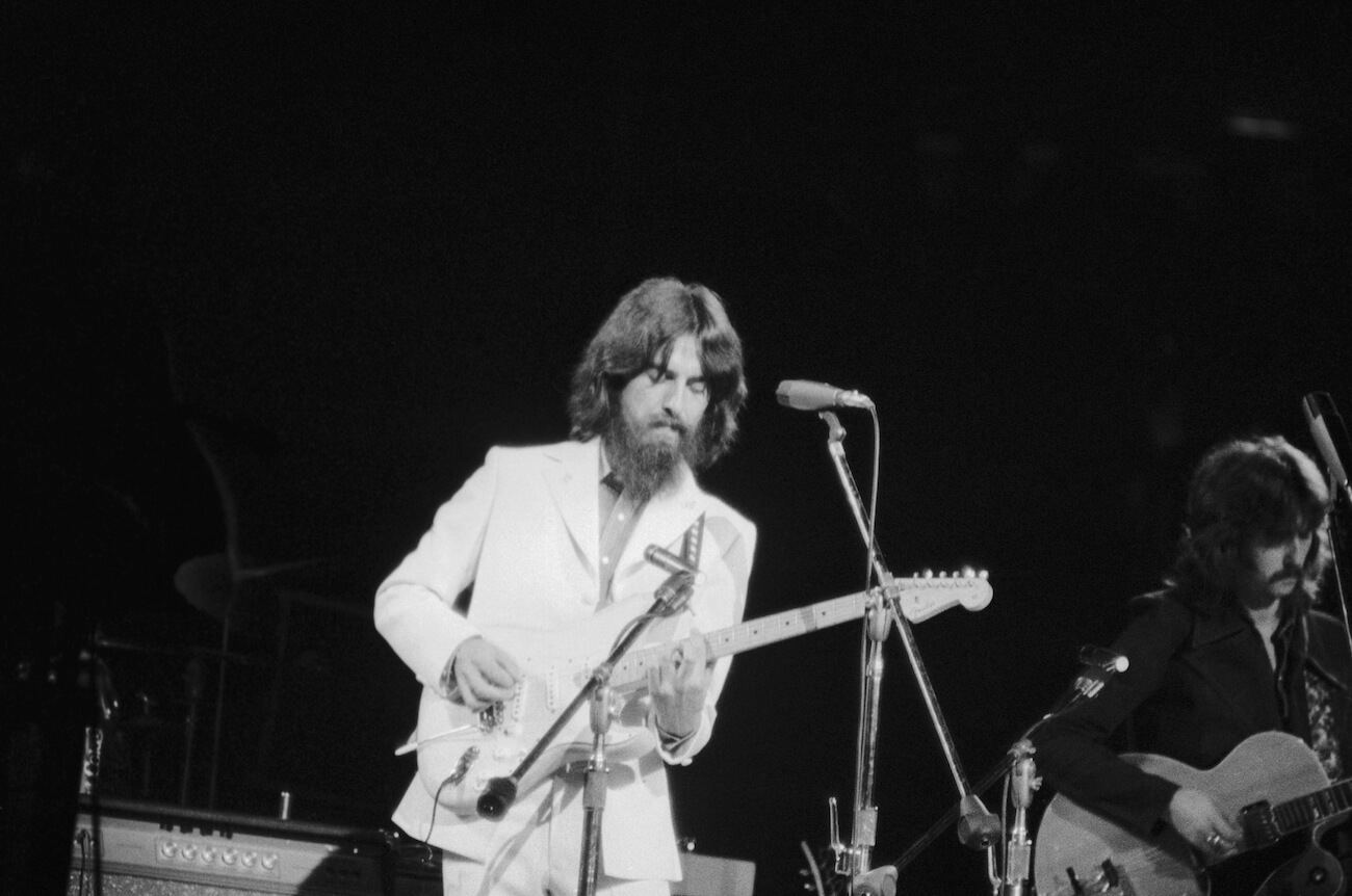 George Harrison performing and playing guitar at the Concert for Bangladesh in 1971.