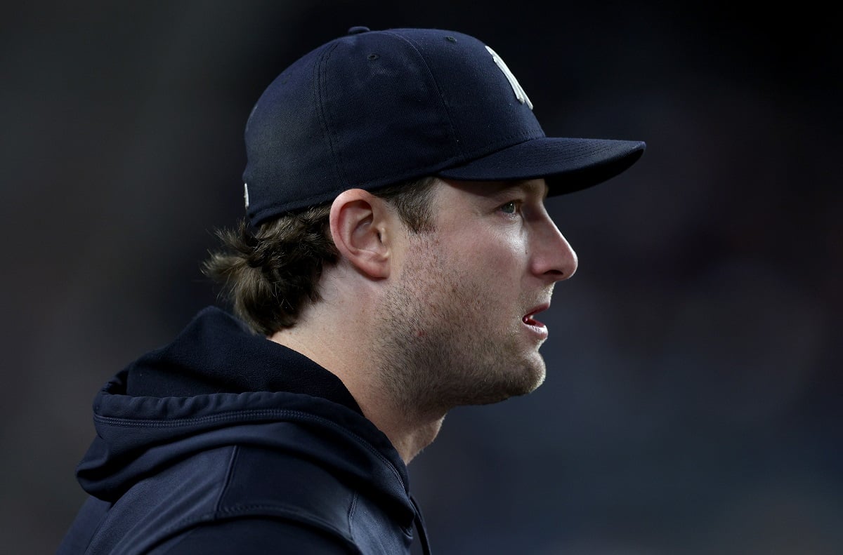 Garrit Cole watches from the dugout during a Yankees game in September 2022