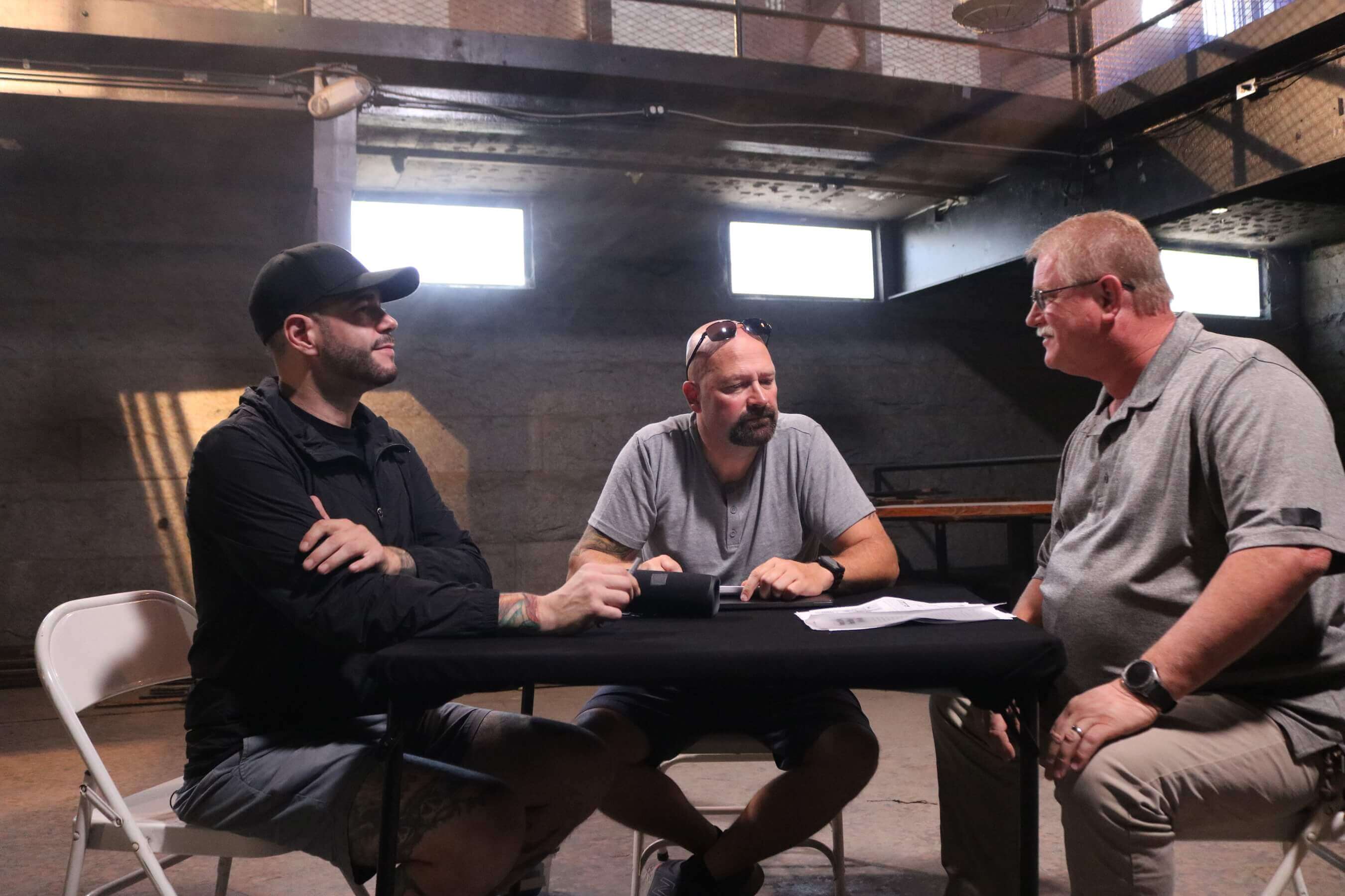 Jason Hawes and Steve Gonsalves sit with their client to discuss The Bastille in the Ghost Hunters Season 16 premiere