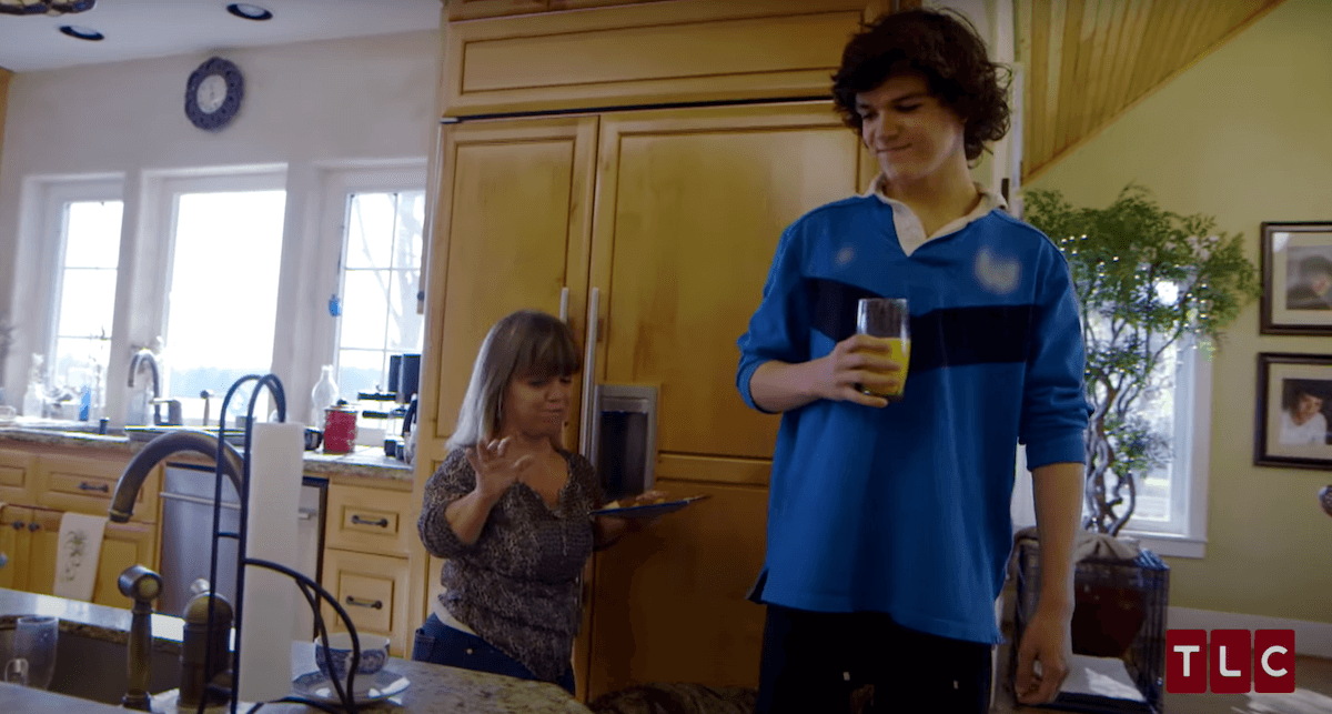 Jacob Roloff of 'Little People, Big World' holding a glass and standing next to his mom Amy Roloff