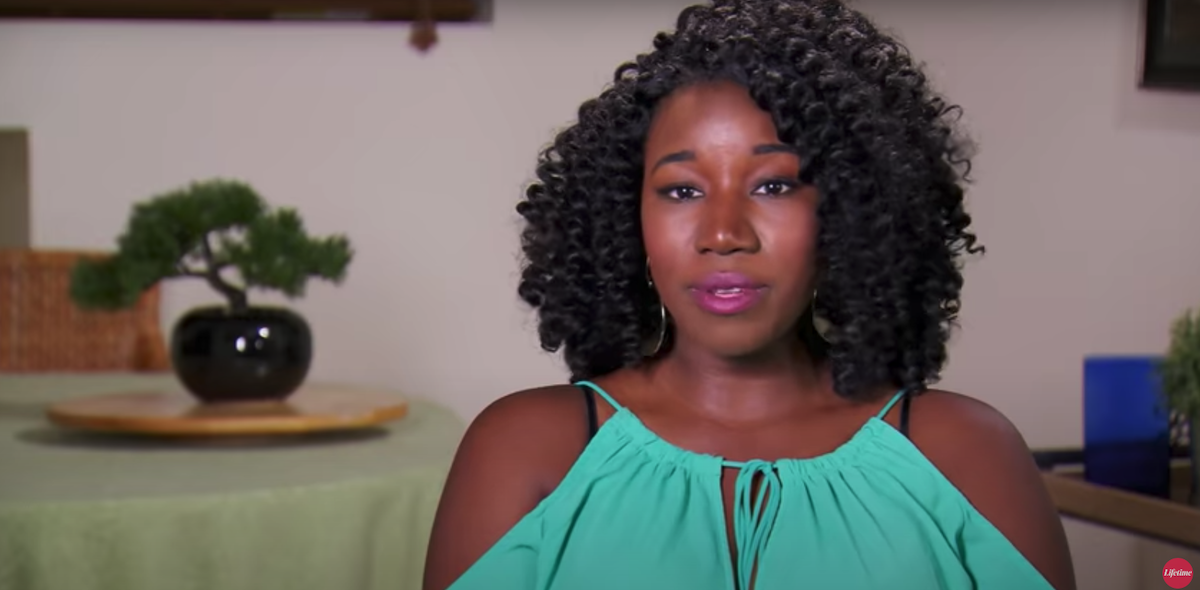 Jasmine McGriff from 'Married at First Sight' Season 8 with curly hair and a teal top