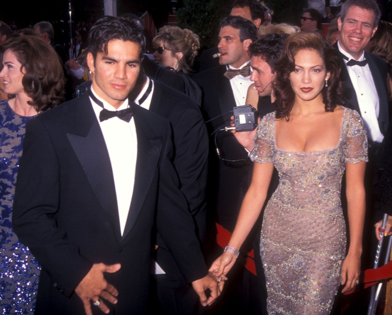 Jennifer Lopez and Ojani Noa hold hands during an event. 