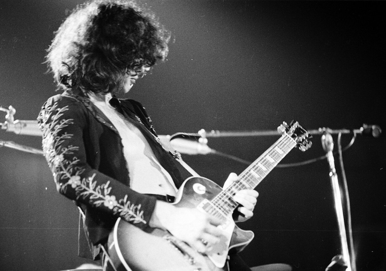 Jimmy Page wears a dark jacket while he plays a Gibson Les Paul during a concert circa 1970.