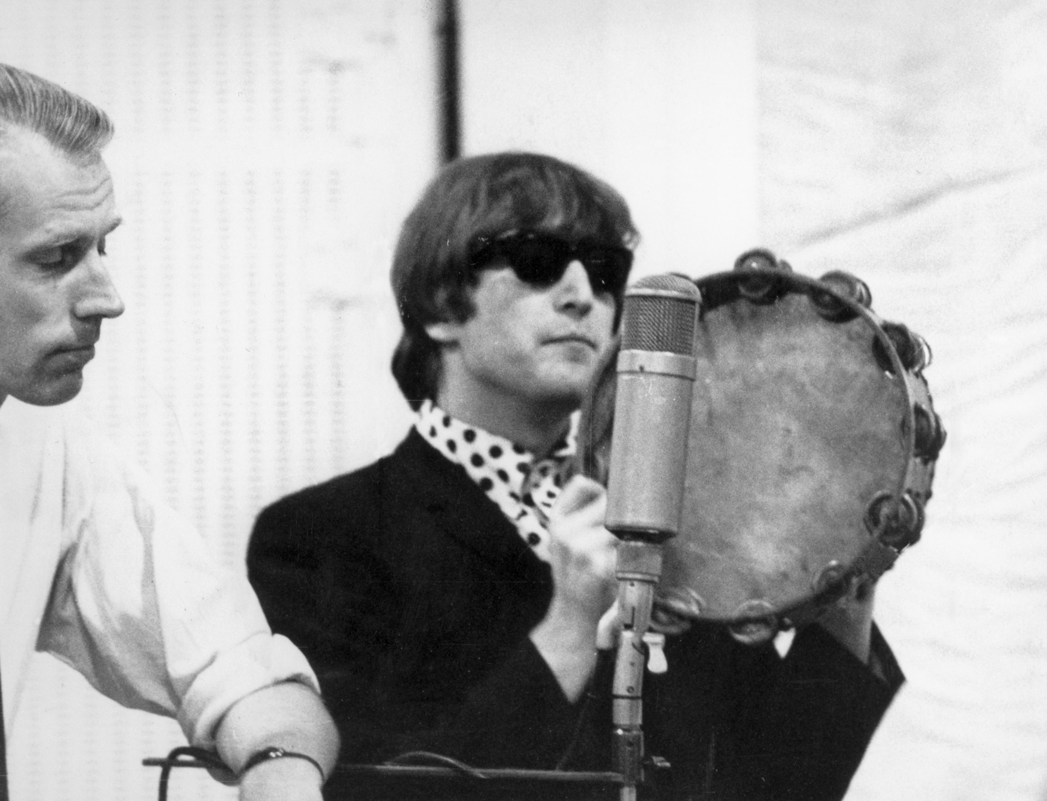 George Martin and John Lennon at a recording session for The Beatles