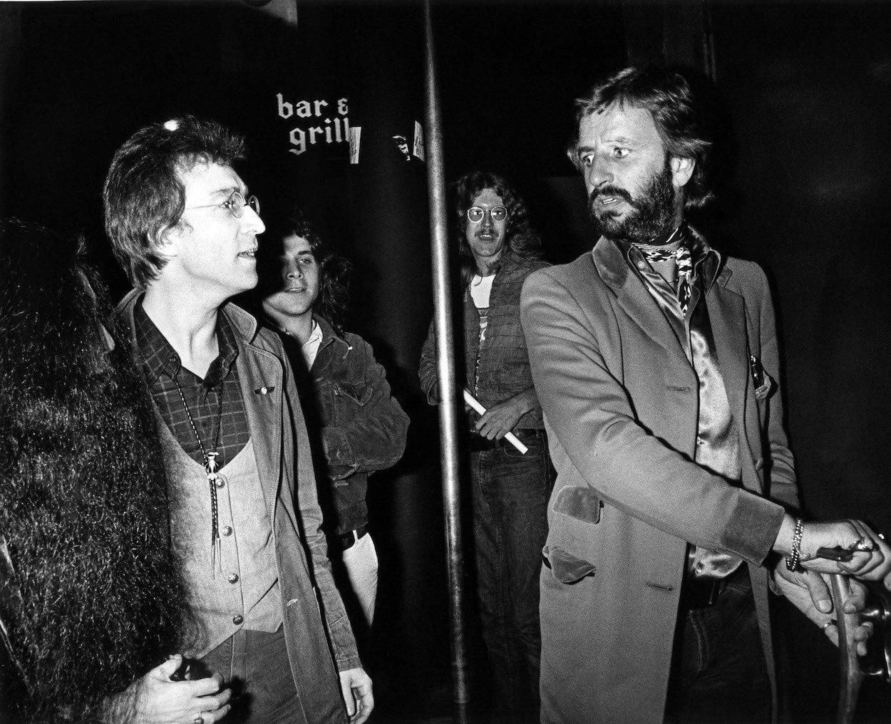 John Lennon (left) walks alongside Ringo Starr arrive at a Los Angeles club in 1975.