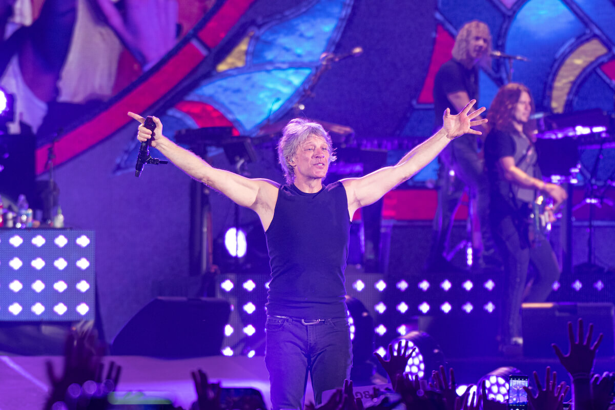 Jon Bon Jovi on stage with his arms open
