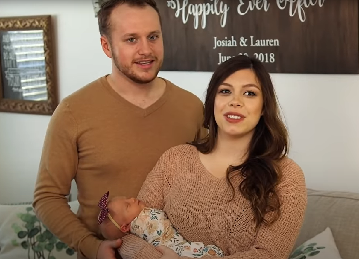 Josiah and Lauren Duggar, with baby Bella Duggar, stand in their living room during an episode of 'Counting On'