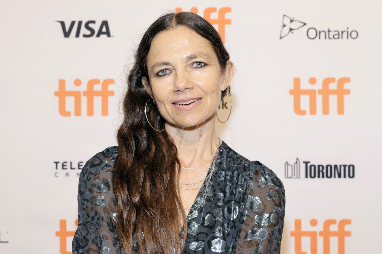 Justine Bateman attends an event while wearing a dress with silver designs.