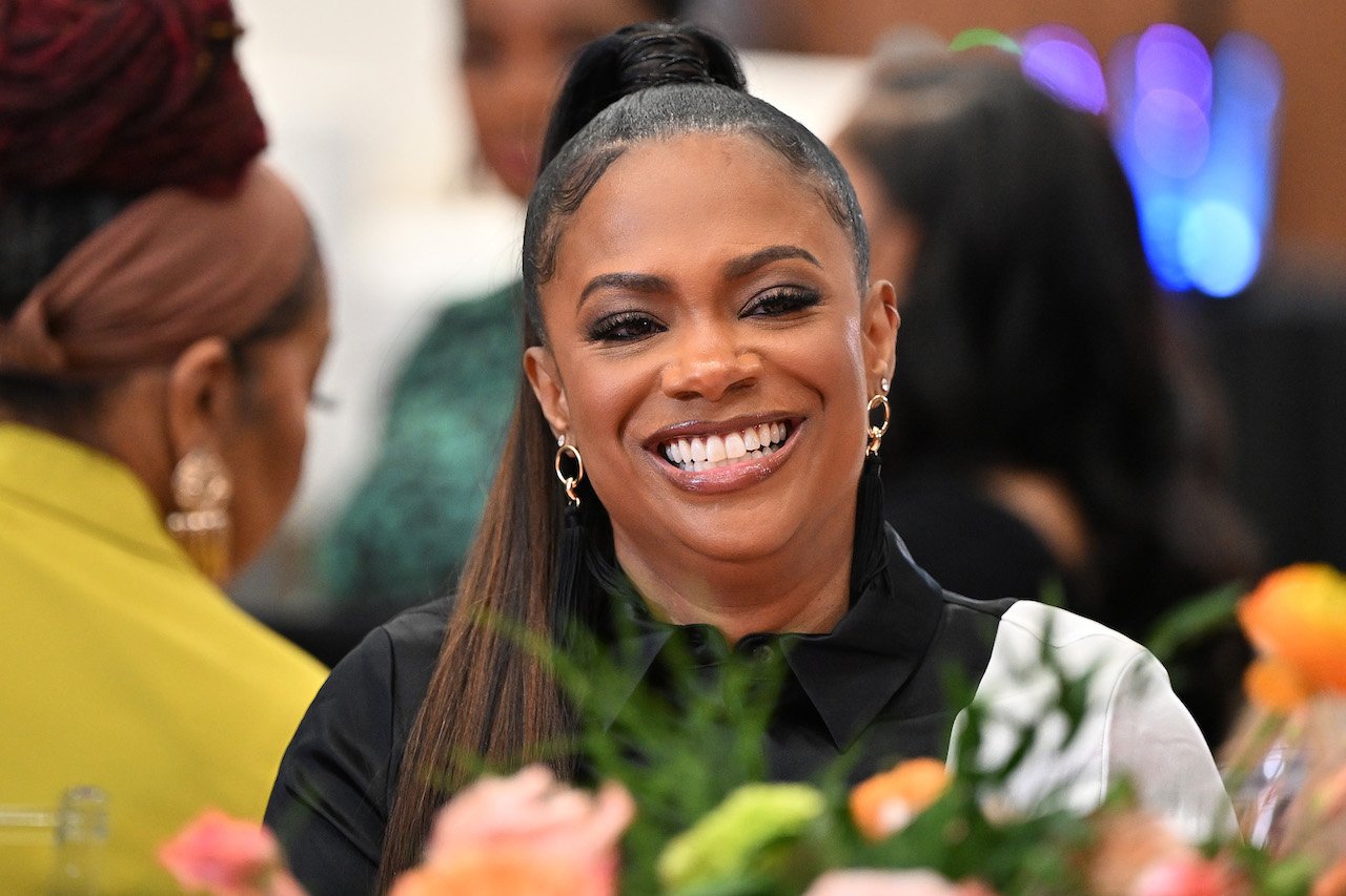 Kandi Burruss smiles during 'RHOA' filming; Burruss says she doesn't agree that Robyn Dixon of 'RHOP' should be fired