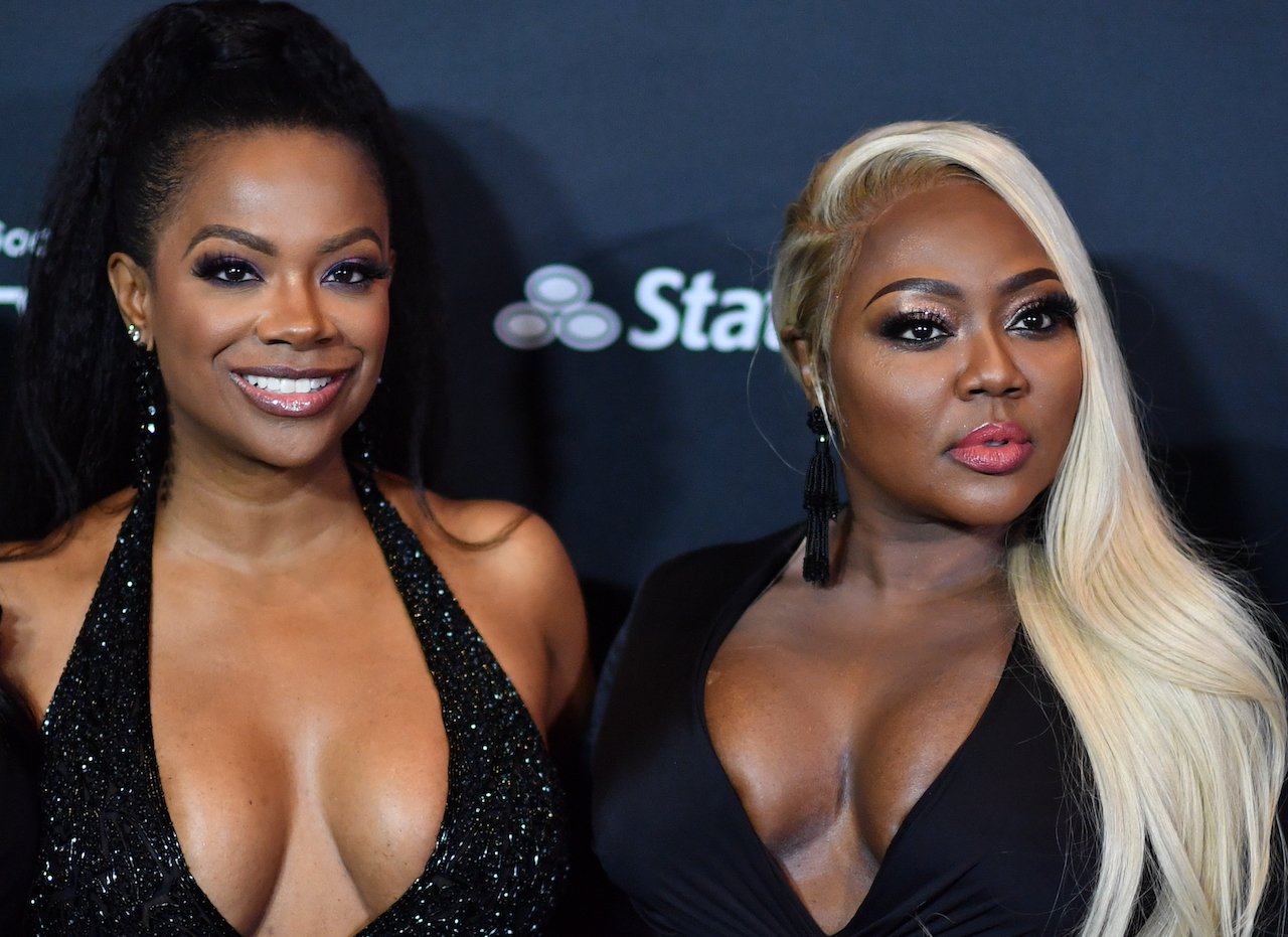 Kandi Burruss and Latocha Scott pose together on the red carpet; Burruss and Scott previously got into a fist fight