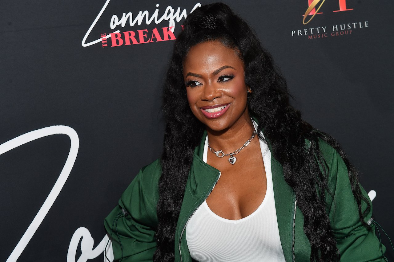 Kandi Burruss poses on red carpet; Burruss and reality TV producer Carlos King fell out after he sold a biopic about her group's life without her consent