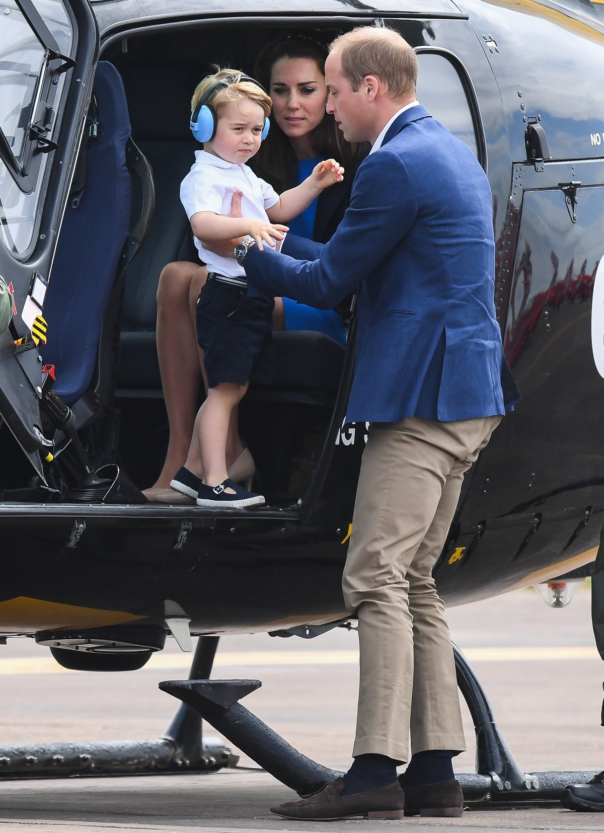 Kate Middleton, Prince George, and Prince William in a helicopter as they attend the The Royal International Air Tattoo
