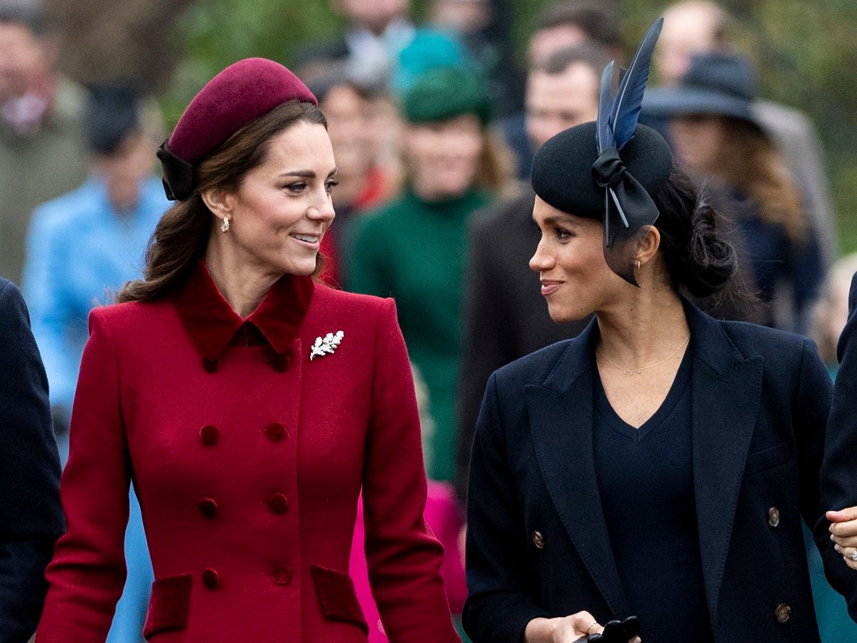 Kate Middleton and Meghan Markle looking at one another as they walked to church on Christmas Day