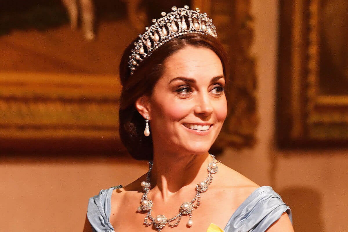 Kate Middleton, who may not wear a tiara to the coronation of King Charles III, looks on wearing the Lover's Knot Tiara