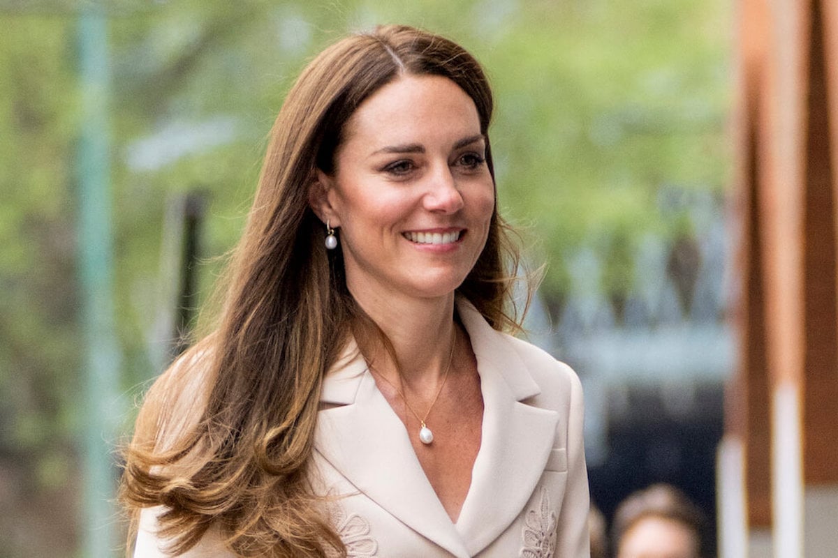 Kate Middleton wears a pineapple-embroidered suit and looks on