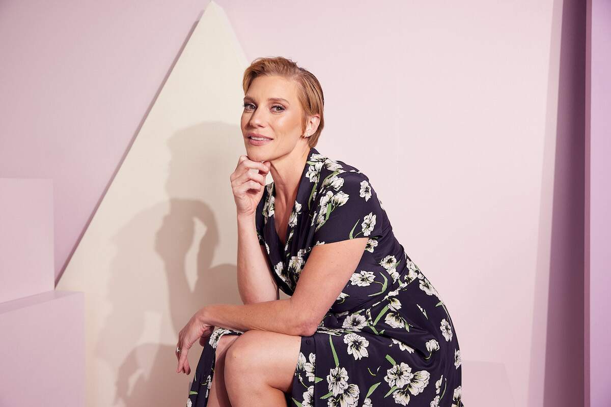 Katee Sackhoff poses in a navy dress at the IMDb Official Portrait Studio in 2022