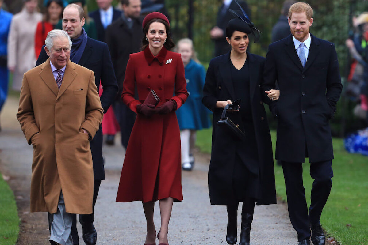 King Charles and Prince William, who decided on a 'clear strategy' after Prince Harry and Meghan Markle's Oprah interview, according to Robert Jobson's 'New King' book, walk with Kate Middleton, Meghan Markle, and Prince Harry