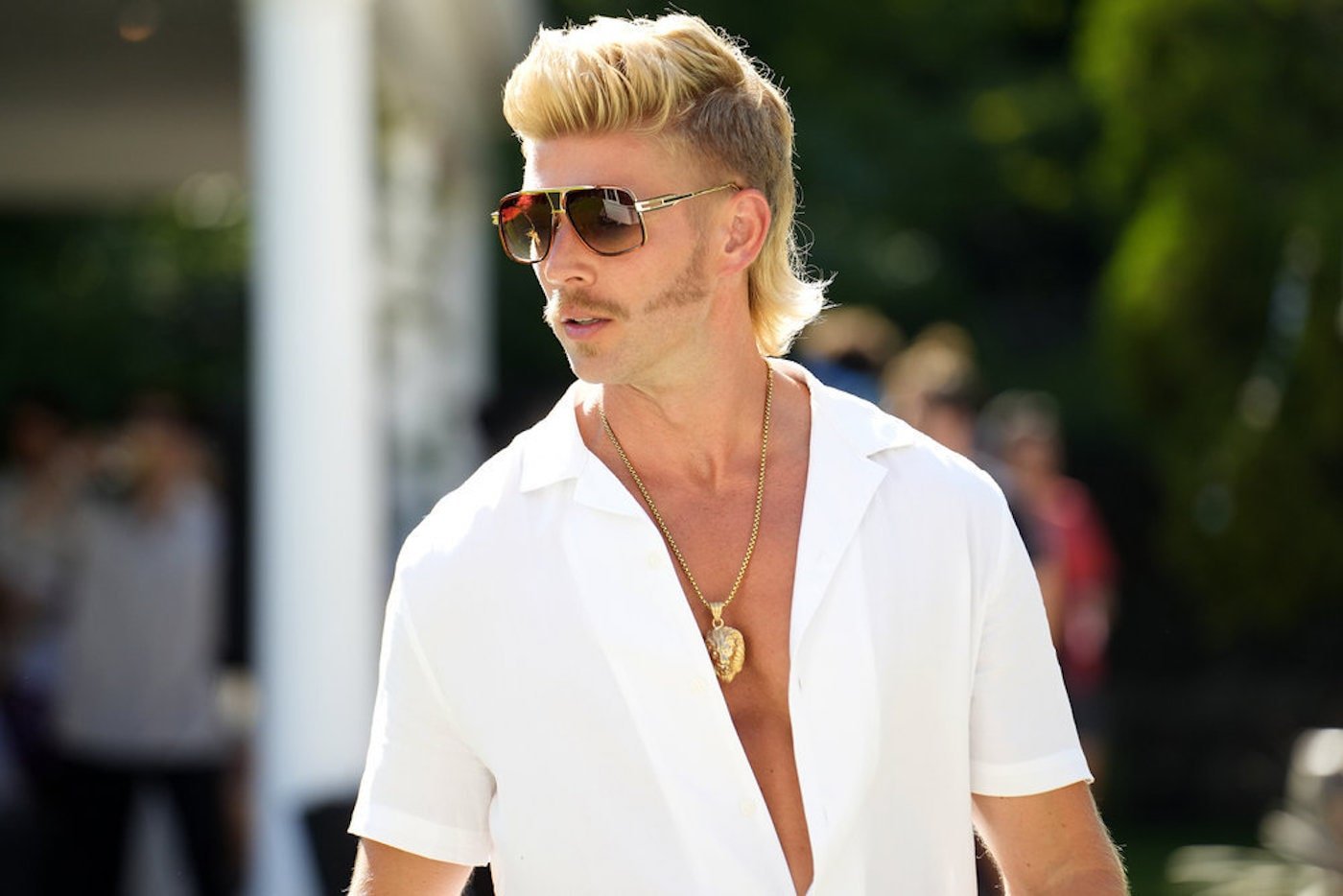 Kyle Cooke from 'Summer House' wears sunglasses and a white shirt