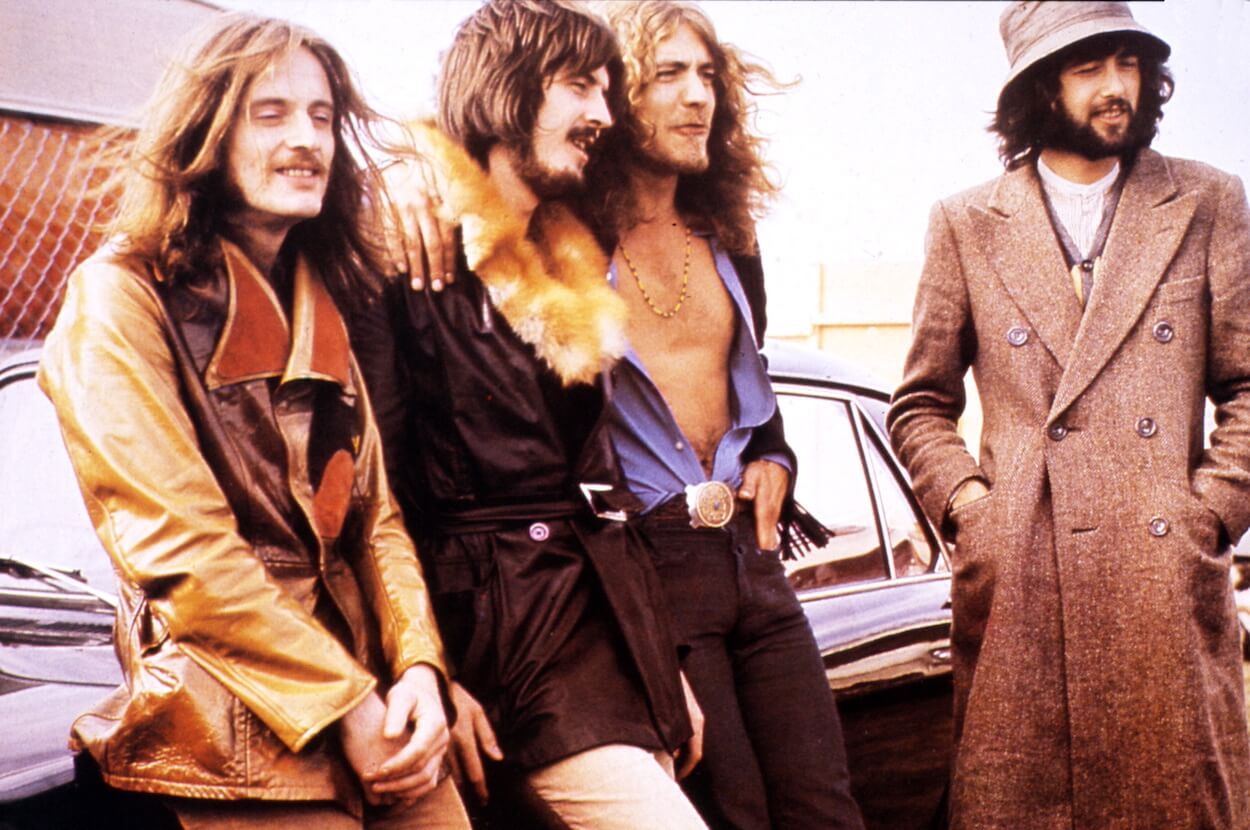 Led Zeppelin members (from left) John Paul Jones, John Bonham, Robert Plant, and Jimmy Page stand near a car circa 1970.