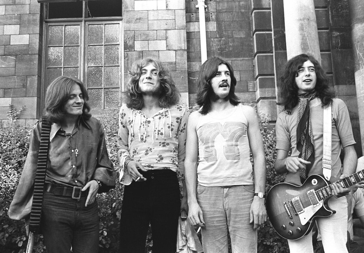 Led Zeppelin members (from left) John Paul Jones, Robert Plant, John Bonham, and Jimmy Page stand in front of a stone building in 1969.