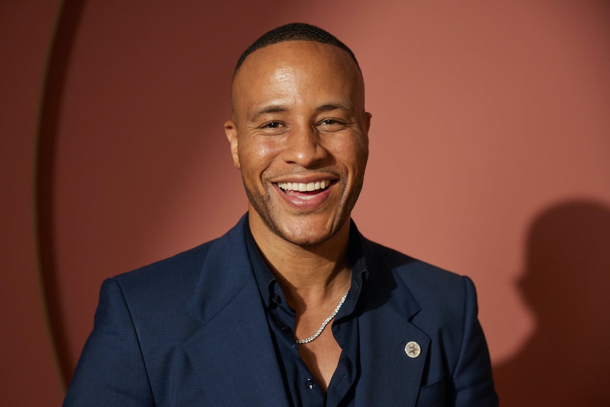 'Married at First Sight' cast member Devon Franklin smiling and wearing a blue jacket