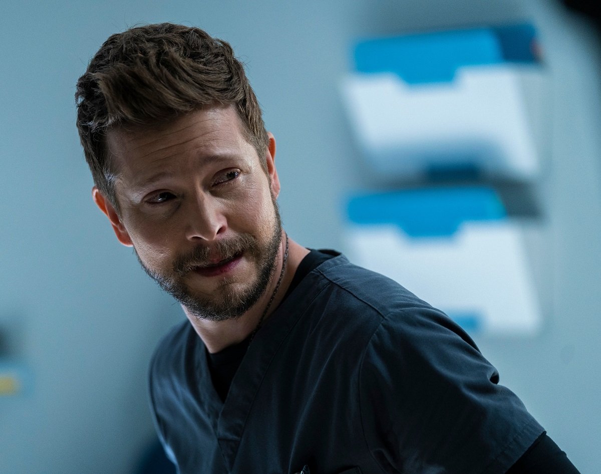 Matt Czuchry as Dr. Conrad Hawkins dressed in scrubs, in 'The Resident' 