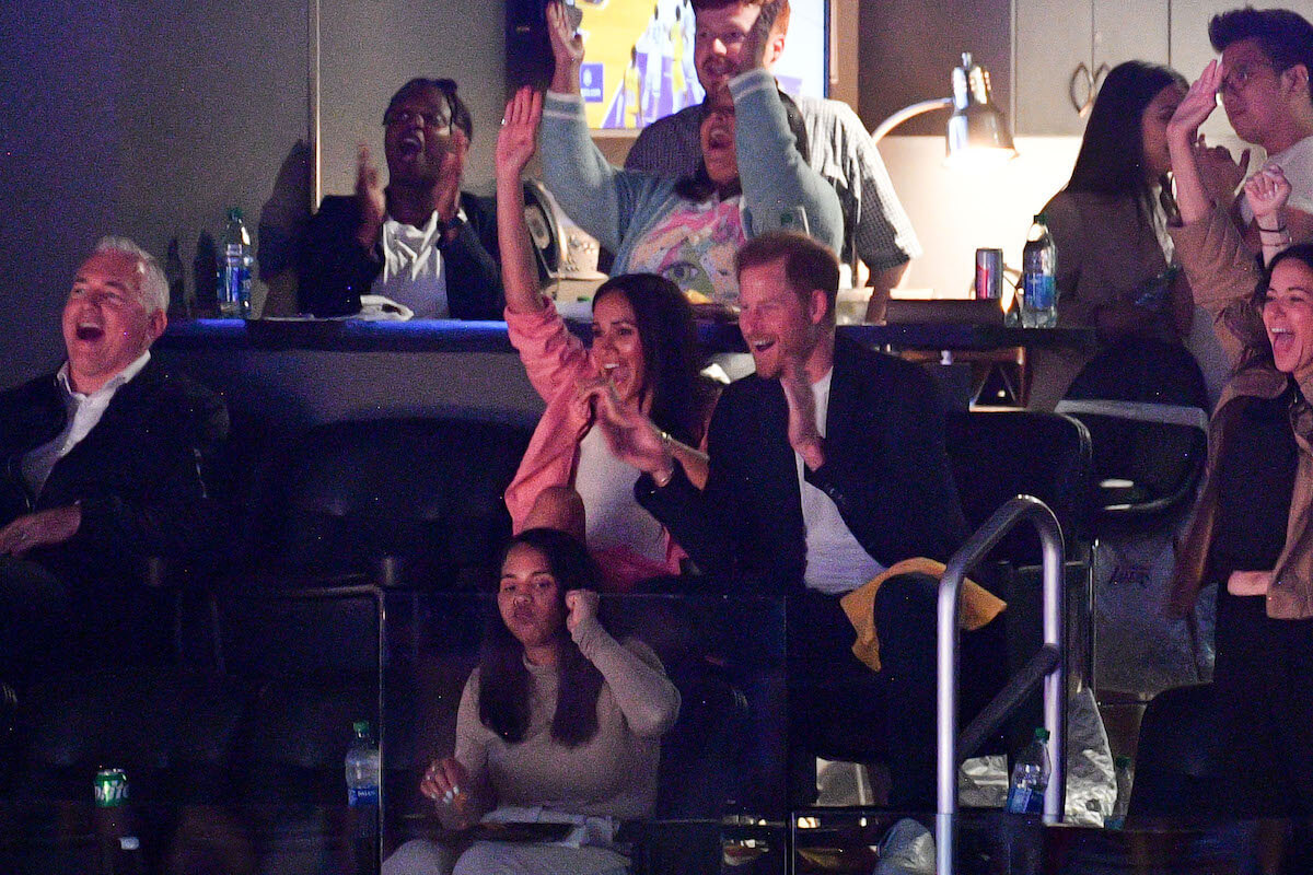 Meghan Markle and Prince Harry, who appeared on the kiss cam at an LA Lakers game, cheer