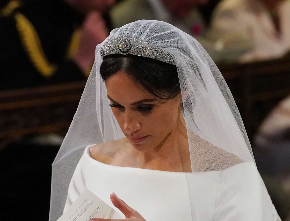 Meghan Markle, who won't be able to wear a tiara to King Charles' coronation, wearing Queen Mary's diamond bandeau tiara at her wedding to Prince Harry