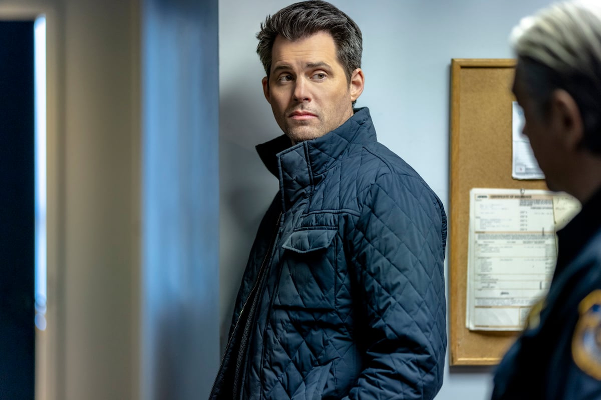 Kristoffer Polaha wearing a blue jacket in 'Mystery 101: Deadly History' on Hallmark Movies & Mysteries