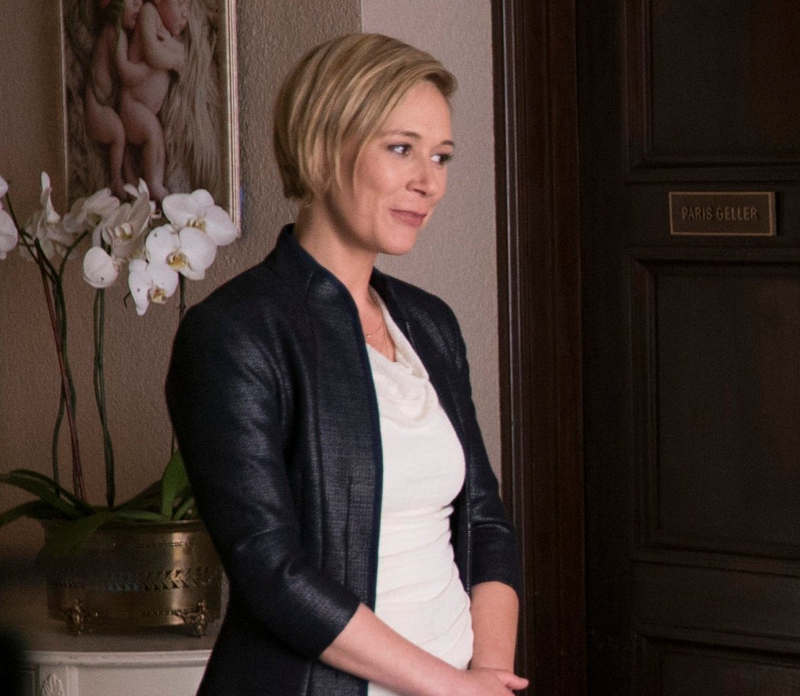 Liza Weil wearing a black leather jacket stands in front of her office door in 'Gilmore Girls: A Year in the Life'